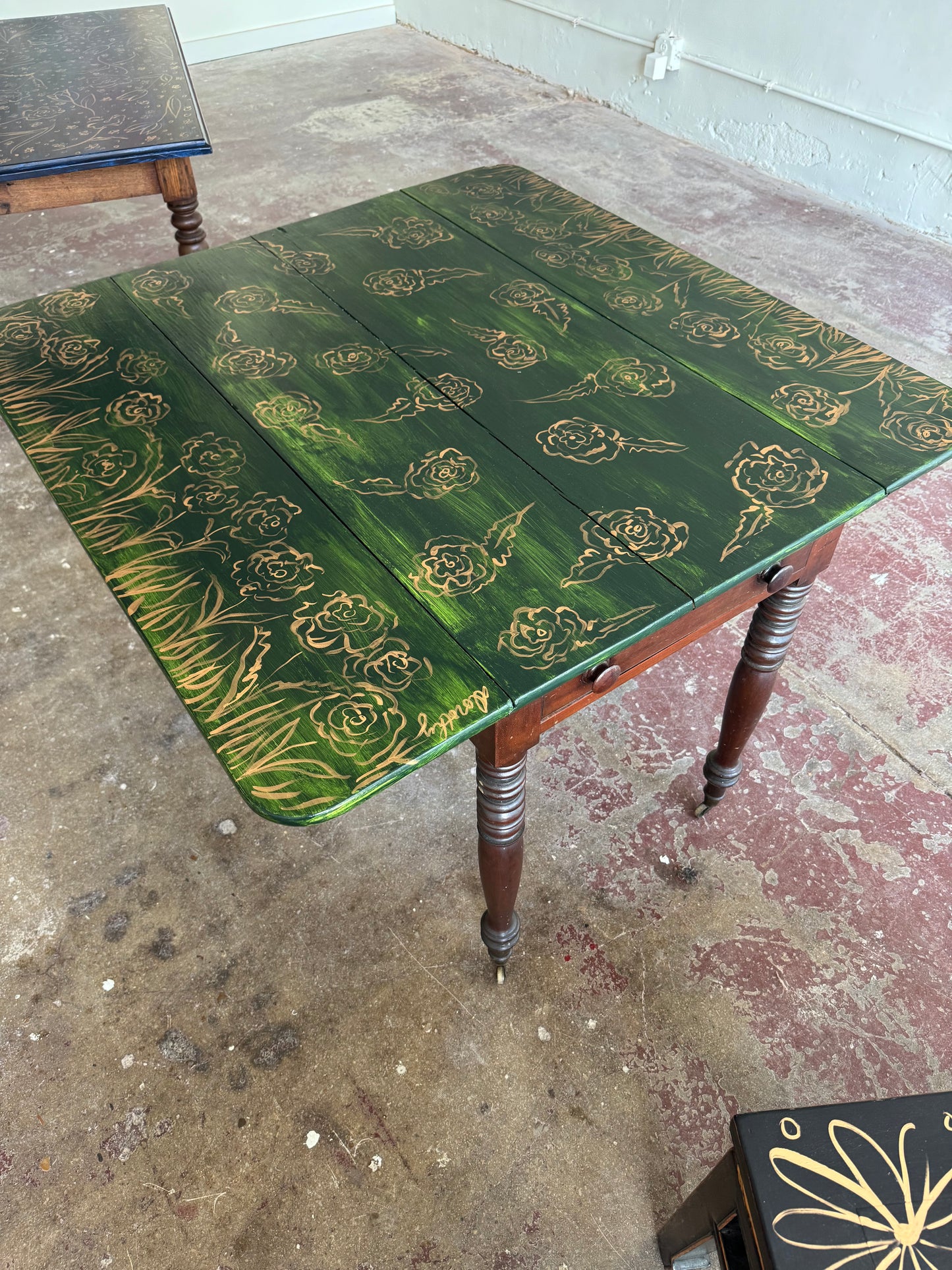 “Enchanted Meadow” by Dorothy Collier, mixed media on vintage drop leaf game table