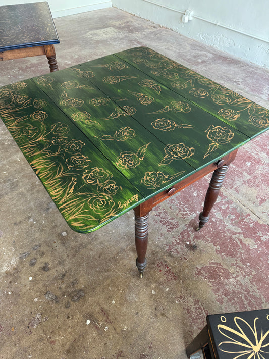 “Enchanted Meadow” by Dorothy Collier, mixed media on vintage drop leaf game table